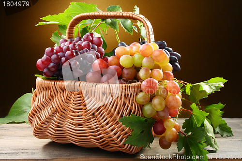 Image of Basket with pink and black grapes.