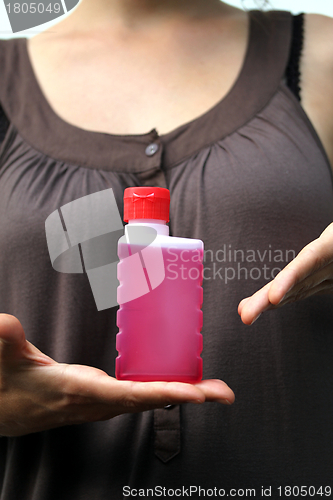 Image of red fluid in hands