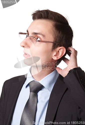 Image of Young businessman in glasses thinking