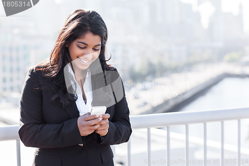 Image of Indian businesswoman texting on the phone