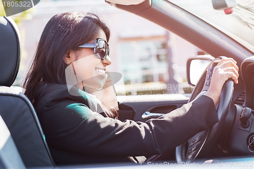 Image of Indian busineswoman driving car