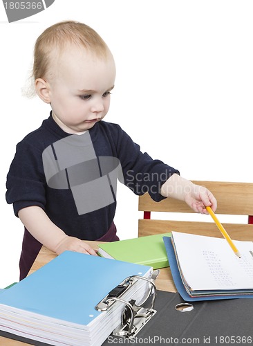 Image of young child at writing desk