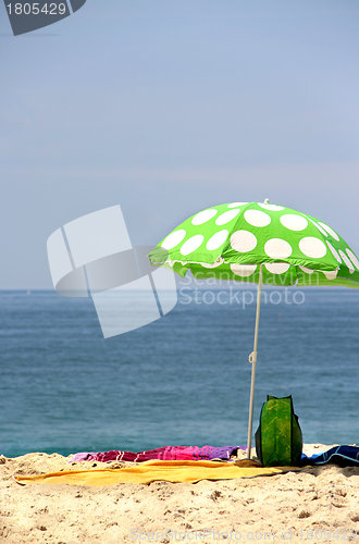 Image of Funny green sun ubrella on the beach