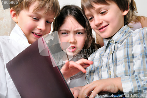 Image of group of children friends playing studying at laptop