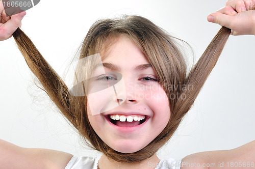 Image of funny girl playing with her hair