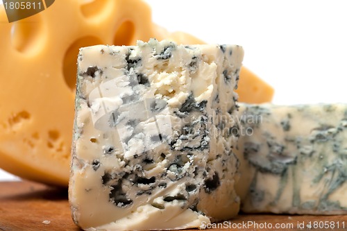 Image of Dorblu and other cheeses on wooden kitchen board