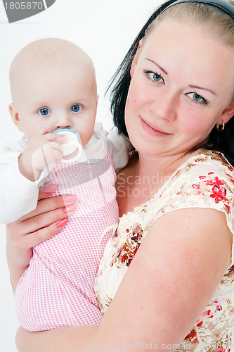 Image of baby with a pacifier in the arms of mother