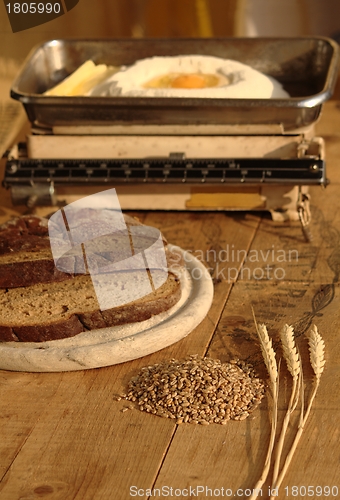 Image of Wheat with bread, eggs, flour and old kitchen scales