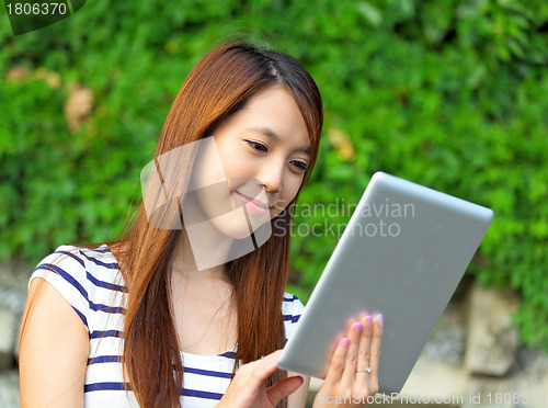 Image of young woman using tablet touch computer