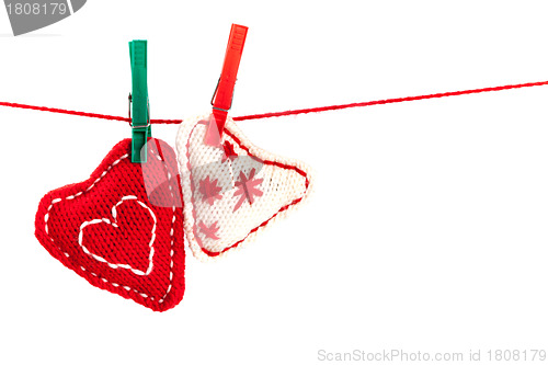 Image of two knitted hearts on a red string