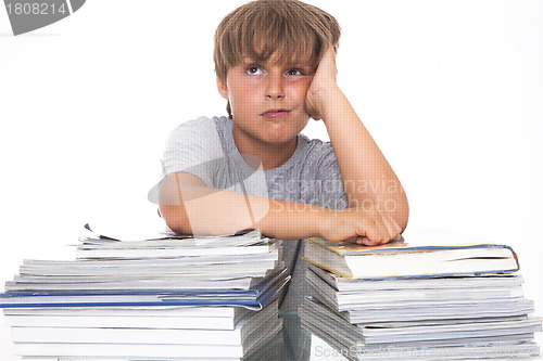 Image of Portrait of a stressed young student with a pile of books to rea