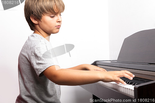 Image of Young boy playing piano 