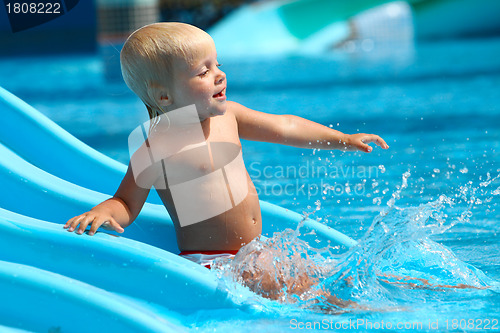 Image of Child on water slide at aquapark.