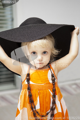 Image of cute little girl in black hat 