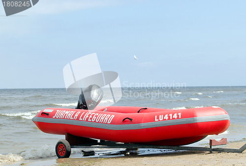 Image of Rubber lifeguard boat trailer on sea shore 