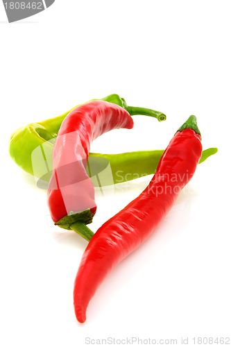 Image of Two red and one green pepper.
