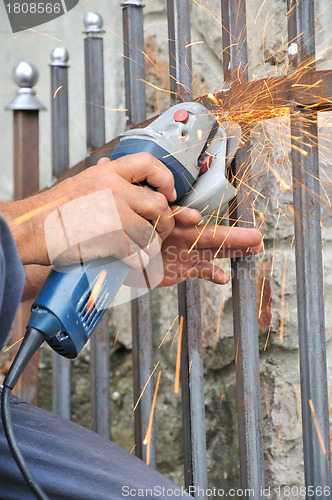 Image of Worker hands with grinder