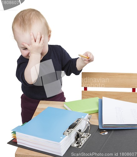 Image of young child at writing desk