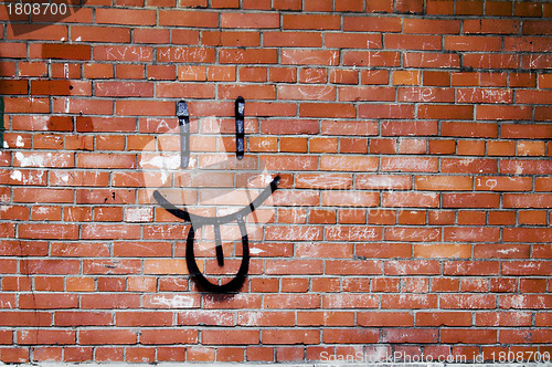 Image of Brick Wall and Smile Graffiti 