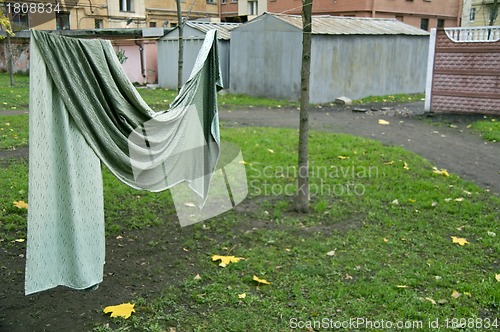 Image of Curtain drying on string in backyard 