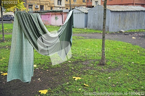 Image of Curtain drying on string in backyard
