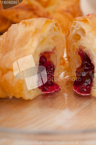 Image of croissant French brioche filled with berries jam