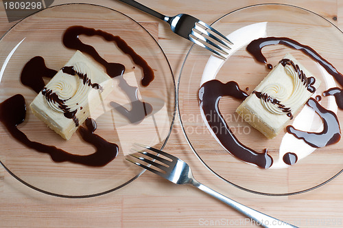 Image of fresh cream cake closeup with chocolate sauce