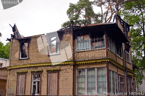 Image of Abandoned old wooden retro house with burnt roof 
