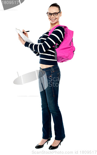Image of Teenage college student writing notes