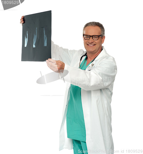 Image of Smiling doctor in glasses reviewing x-ray report