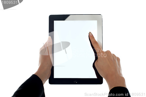 Image of Closeup shot of female finger operating tablet