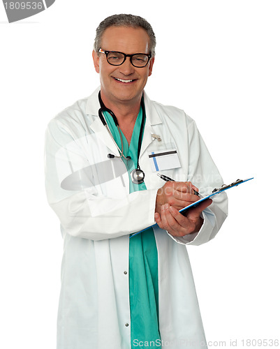 Image of Experienced male doctor making report
