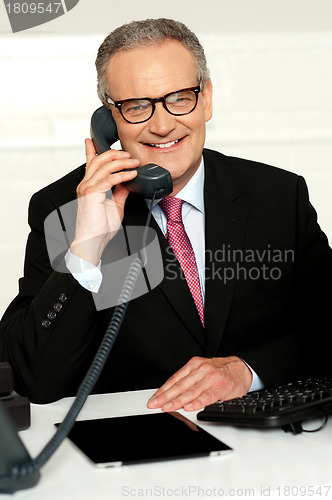 Image of Smiling aged man communicating with his client