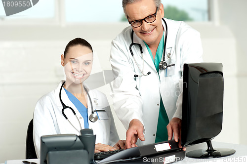 Image of Team of doctors working on computer