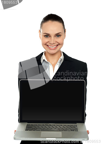 Image of Female executive presenting brand new laptop