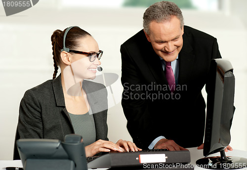 Image of Corporate team working together on computer
