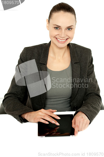 Image of Pretty businesswoman using tablet device
