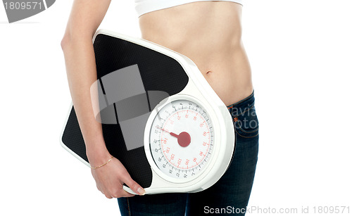 Image of Closeup shot, woman carrying weighing machine