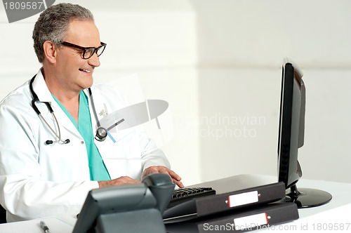 Image of Experienced doctor working on computer