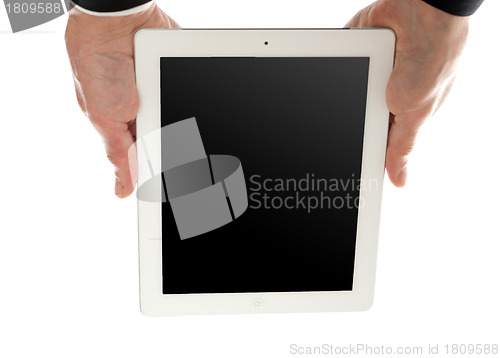 Image of Man holding tablet device upside down