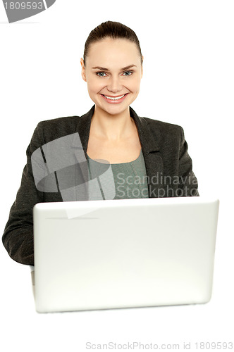 Image of Attractive corporate female working on laptop