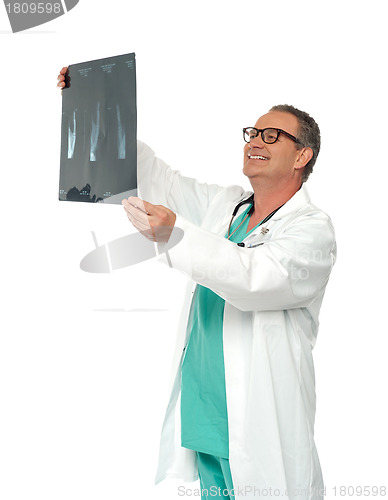 Image of Experienced surgeon looking at x-ray report