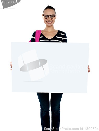 Image of Teenager presenting white blank billboard