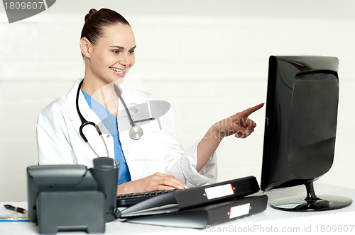 Image of Female medical expert pointing at computer screen