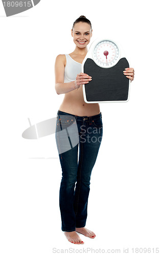 Image of Full frame woman holding a scale