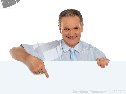 Image of Casual male promoter pointing at blank billboard