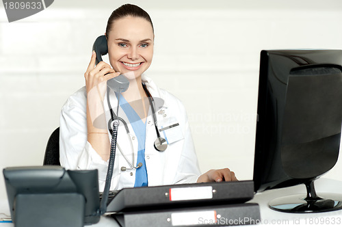 Image of Young smiling physician sitting in clinic