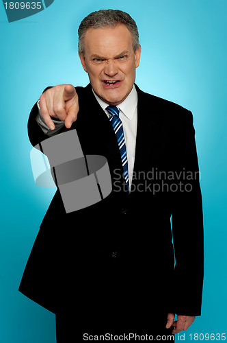 Image of Angry senior businessman pointing finger at you