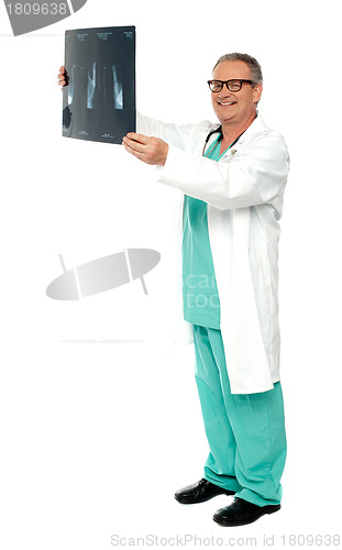 Image of Full length shot of a surgeon with x-ray report