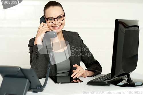 Image of Businesswoman in glasses communicating on phone